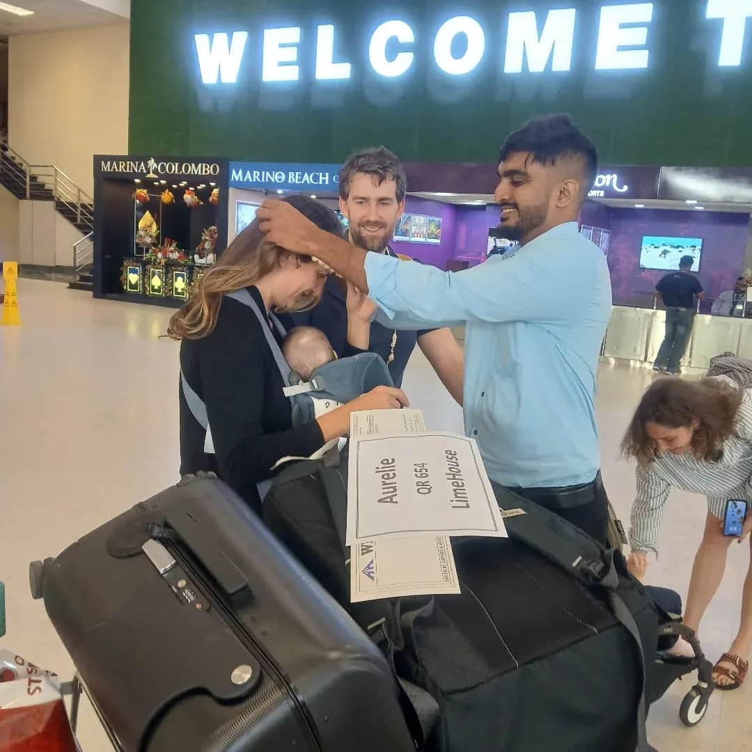 A CeilonTravels driver meeting arriving guests with a name board in the arrivals hall at Bandaranaike International Airport
