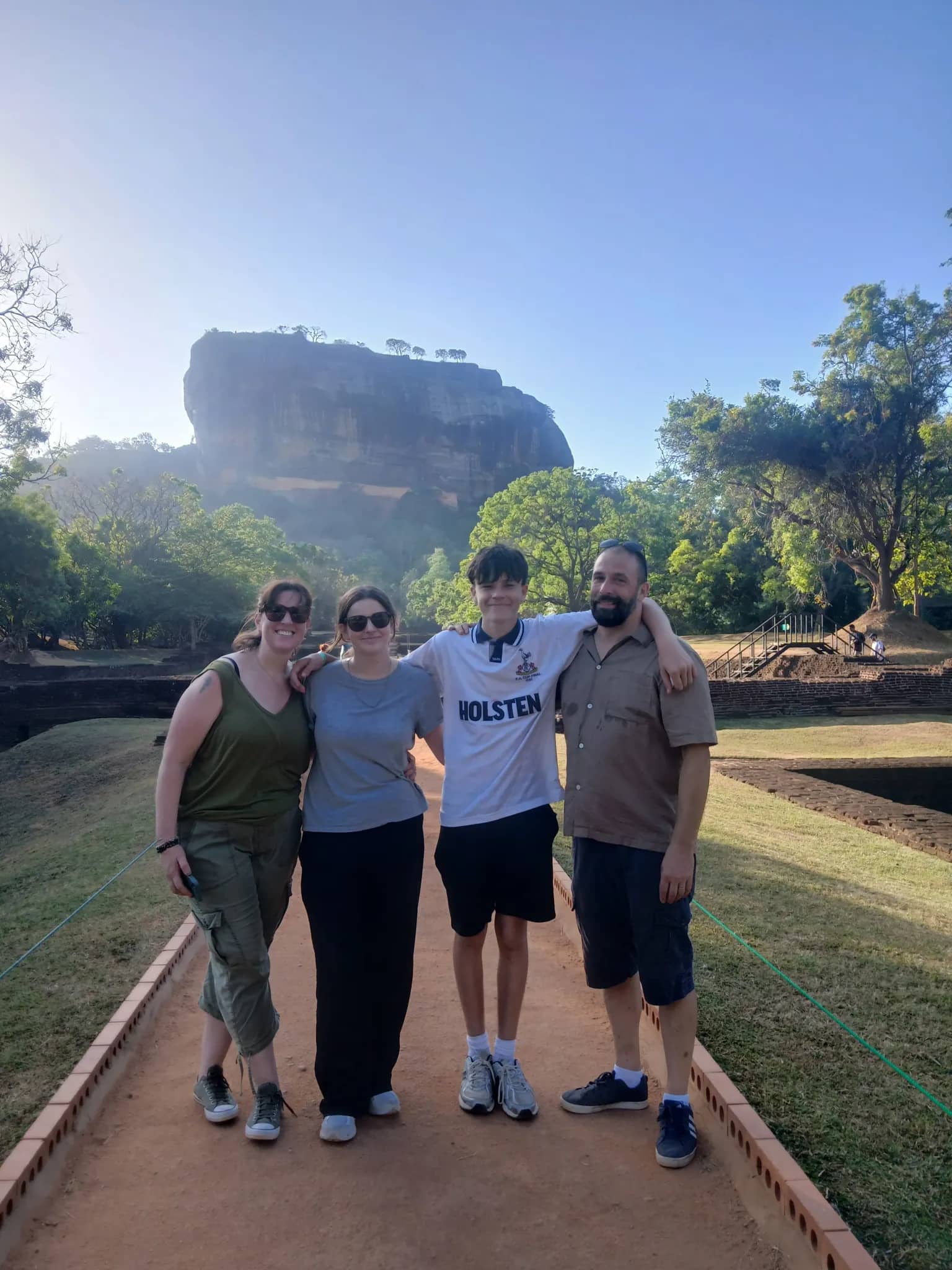 A family on a CeilonTravels guided tour in front of Sigiriya Rock