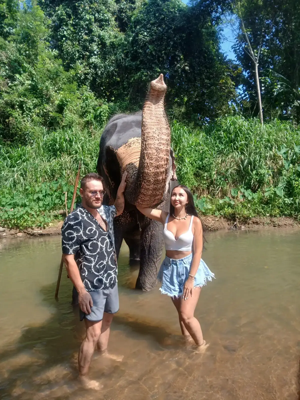 Travellers meeting an elephant in a river in Sri Lanka